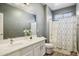 Bathroom with gray walls, white cabinets, shower, toilet, and large mirror providing plenty of space at 46141 W Rainbow Dr, Maricopa, AZ 85139
