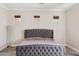 Cozy bedroom featuring a tufted headboard, recessed lighting, and natural light at 46141 W Rainbow Dr, Maricopa, AZ 85139