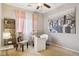 Bedroom with a window, fan, black and white artwork, and decor with a desk and office chair at 46141 W Rainbow Dr, Maricopa, AZ 85139