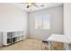 Minimalist bedroom featuring a ceiling fan, a window, and a functional layout for furniture at 46141 W Rainbow Dr, Maricopa, AZ 85139
