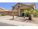 Inviting two-story home featuring a well-manicured front yard with mature palm trees and a three-car garage at 46141 W Rainbow Dr, Maricopa, AZ 85139