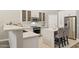Modern kitchen featuring stainless steel appliances, white cabinets, and breakfast bar seating at 46141 W Rainbow Dr, Maricopa, AZ 85139