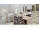 Bright kitchen features white cabinets, stainless steel appliances and countertop seating at 46141 W Rainbow Dr, Maricopa, AZ 85139