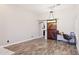 Bright living room featuring wood floors, a sliding barn door, and a modern lighting fixture at 46141 W Rainbow Dr, Maricopa, AZ 85139