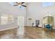 Bright living room boasts high ceilings, wood floors, and abundant natural light at 46141 W Rainbow Dr, Maricopa, AZ 85139