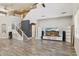 Open-concept living room features a staircase, modern decor and sleek wood floors at 46141 W Rainbow Dr, Maricopa, AZ 85139