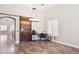 Bright living room with wood floors, large windows, and a sliding barn door at 46141 W Rainbow Dr, Maricopa, AZ 85139