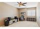 Comfortable upper-level living area, with a ceiling fan, neutral tones, and versatile layout at 46141 W Rainbow Dr, Maricopa, AZ 85139