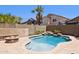 Backyard pool features a small waterfall, a firepit, and is surrounded by plants and a fence at 46141 W Rainbow Dr, Maricopa, AZ 85139