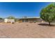 Backyard features a gravel ground cover, and an enclosed screened-in patio at 5309 E Butte St, Mesa, AZ 85205
