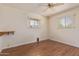 Bright bedroom features wood floors, ceiling fan, and natural light from two windows at 5309 E Butte St, Mesa, AZ 85205