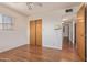 Bedroom features wood floors, closet with bi-fold doors, and access to the hallway at 5309 E Butte St, Mesa, AZ 85205