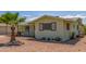 A cozy single-story home with desert landscaping featuring cacti and a young palm tree at 5309 E Butte St, Mesa, AZ 85205