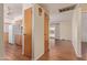 Hallway featuring wood floors, closets, and access to the kitchen and living room spaces at 5309 E Butte St, Mesa, AZ 85205