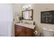 Bathroom featuring modern vanity, mirror, toilet, and floral wall art at 5343 W Vogel Ave, Glendale, AZ 85302