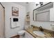 Bright bathroom features granite counters, decorative shelving, and a large mirror at 5343 W Vogel Ave, Glendale, AZ 85302