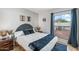 Well-lit bedroom featuring wood-look floors, modern decor, and view to backyard at 5343 W Vogel Ave, Glendale, AZ 85302