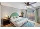 Cozy bedroom featuring neutral walls, ceiling fan, ensuite, and sliding glass doors to yard at 5343 W Vogel Ave, Glendale, AZ 85302