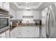 Modern kitchen with stainless steel appliances, white cabinets, and stylish backsplash at 5343 W Vogel Ave, Glendale, AZ 85302