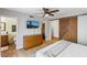 Bright main bedroom with wood-look floors, a ceiling fan, and an ensuite bathroom at 5343 W Vogel Ave, Glendale, AZ 85302