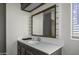 Bathroom with a framed mirror and open window at 53925 W Stallion Rd, Maricopa, AZ 85139