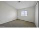 Neutral bedroom featuring carpeted floors, a window, and white walls at 53925 W Stallion Rd, Maricopa, AZ 85139