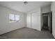 Carpeted bedroom featuring a closet, a window, and views of the outside at 53925 W Stallion Rd, Maricopa, AZ 85139