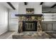Close up of the stone fireplace and hearth, with wood beams on the ceiling at 53925 W Stallion Rd, Maricopa, AZ 85139