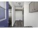Hallway featuring gray wood floors and ample storage with overhead cabinets at 53925 W Stallion Rd, Maricopa, AZ 85139