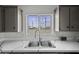 Kitchen sink with modern faucet and window showcasing the backyard at 53925 W Stallion Rd, Maricopa, AZ 85139