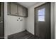 Functional laundry room with storage cabinets and natural light at 53925 W Stallion Rd, Maricopa, AZ 85139