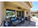 Covered back patio area with ceiling fan offering a comfortable place to relax and enjoy the well manicured lawn at 6712 W Miner Trl, Peoria, AZ 85383