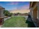 Spacious backyard with lush green lawn and privacy wall at 6712 W Miner Trl, Peoria, AZ 85383