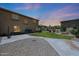 Spacious backyard with lush green lawn, patio, and privacy wall at 6712 W Miner Trl, Peoria, AZ 85383