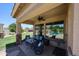 Covered back patio area with ceiling fan offering a comfortable place to relax and enjoy the well manicured lawn at 6712 W Miner Trl, Peoria, AZ 85383