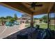 Back patio with ceiling fan and a view of the backyard that includes a seating area and built-in barbeque at 6712 W Miner Trl, Peoria, AZ 85383