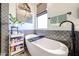 Spa-like bathroom featuring a standalone tub, stylish fixtures, and ample natural light at 6712 W Miner Trl, Peoria, AZ 85383