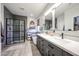 Elegant bathroom with a double vanity, a glass-enclosed shower, and a standalone soaking tub at 6712 W Miner Trl, Peoria, AZ 85383