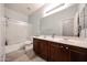 Bathroom featuring dual sinks with dark wood cabinets and a shower/tub combination at 6712 W Miner Trl, Peoria, AZ 85383