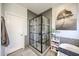 Modern bathroom with a glass enclosed shower featuring gray patterned tile, white vanity and decor at 6712 W Miner Trl, Peoria, AZ 85383