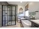 Modern bathroom showcasing a glass-enclosed shower, standalone tub, and stylish tile accents at 6712 W Miner Trl, Peoria, AZ 85383
