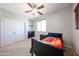 Inviting bedroom featuring a ceiling fan, a bed with a colorful blanket, and a closet at 6712 W Miner Trl, Peoria, AZ 85383