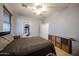Inviting bedroom featuring a ceiling fan, a bed with dark linens, and ample storage space at 6712 W Miner Trl, Peoria, AZ 85383
