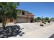Charming two-story home featuring a three-car garage and a well-manicured front yard at 6712 W Miner Trl, Peoria, AZ 85383