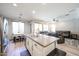 Open-concept kitchen overlooking a living room with a central island, stainless appliances, and lots of light at 6712 W Miner Trl, Peoria, AZ 85383