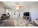 The living room has a comfortable sofa, desk, ceiling fan, and neutral tones at 6712 W Miner Trl, Peoria, AZ 85383