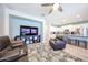 Spacious living room with an open layout to kitchen with leather furniture and ceiling fan at 6712 W Miner Trl, Peoria, AZ 85383