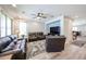 Comfortable living room with leather sofas, neutral walls and flooring, plus lots of light at 6712 W Miner Trl, Peoria, AZ 85383