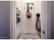 Mud room featuring an 'F' hook, a bench with patterned cushion, and decorative organizers at 6712 W Miner Trl, Peoria, AZ 85383