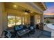 Cozy covered patio with comfortable seating overlooking the pool at 6712 W Miner Trl, Peoria, AZ 85383